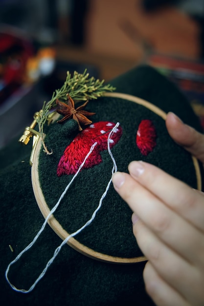 Hands stitching floral embroidery